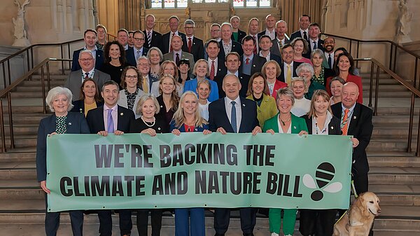 A group of MPs standing in Parliament supporting the Climate and Nature Bill