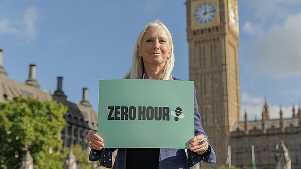 Roz Savage holding Zero Hour sign in front of Big Ben